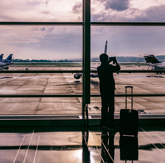 Man Standing In Airport and Capturing photo