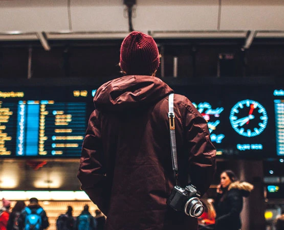 Boy Wearing Red Jacket and Cap And Standing in Airport